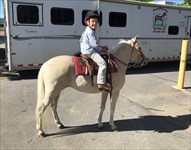grandson, Drake, after riding Diana in class at show in Utah